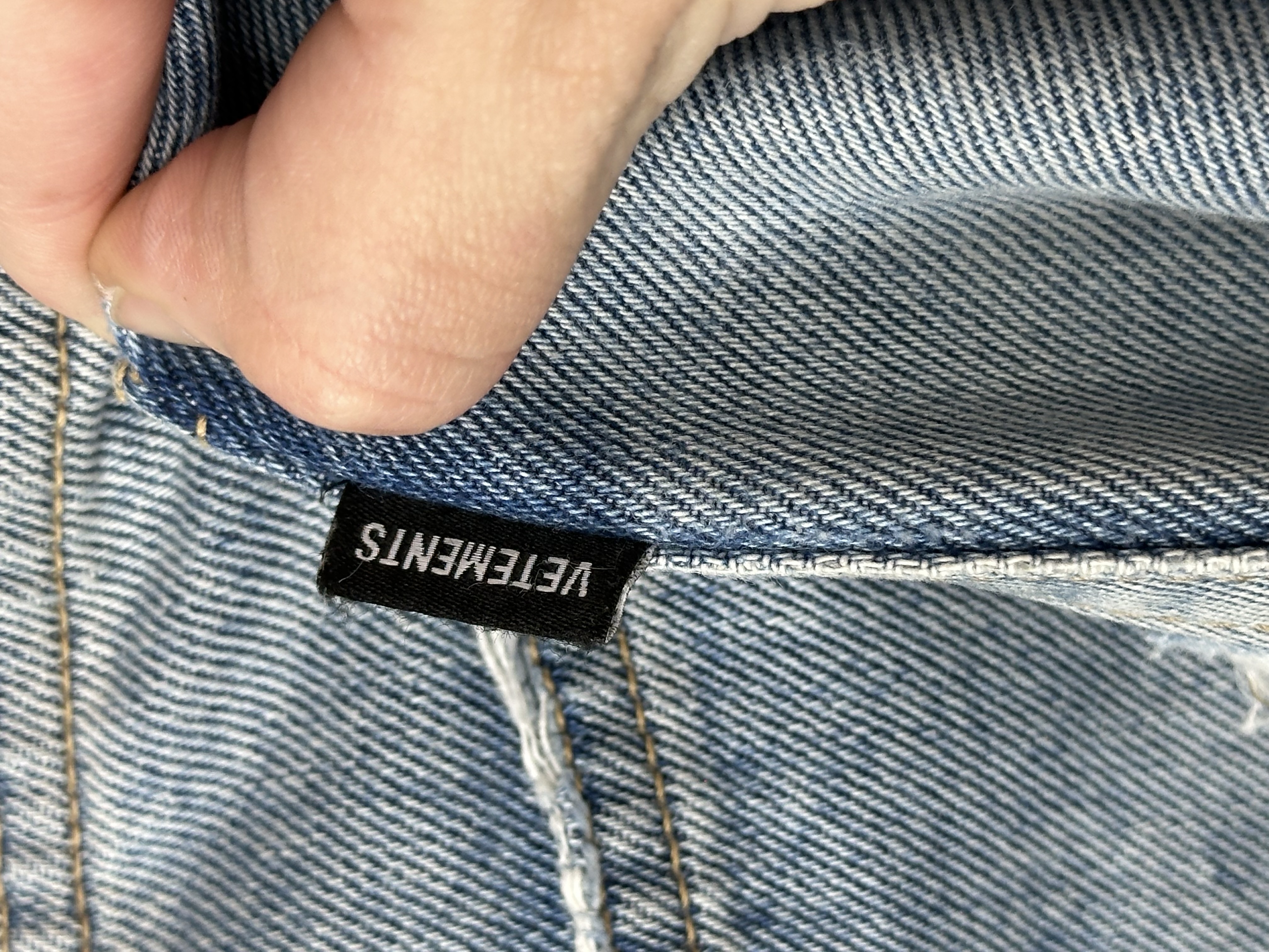 Vetements VETEMENTS FW19 Demna Anarchy Logo Distressed Blue Jeans, detail view 11