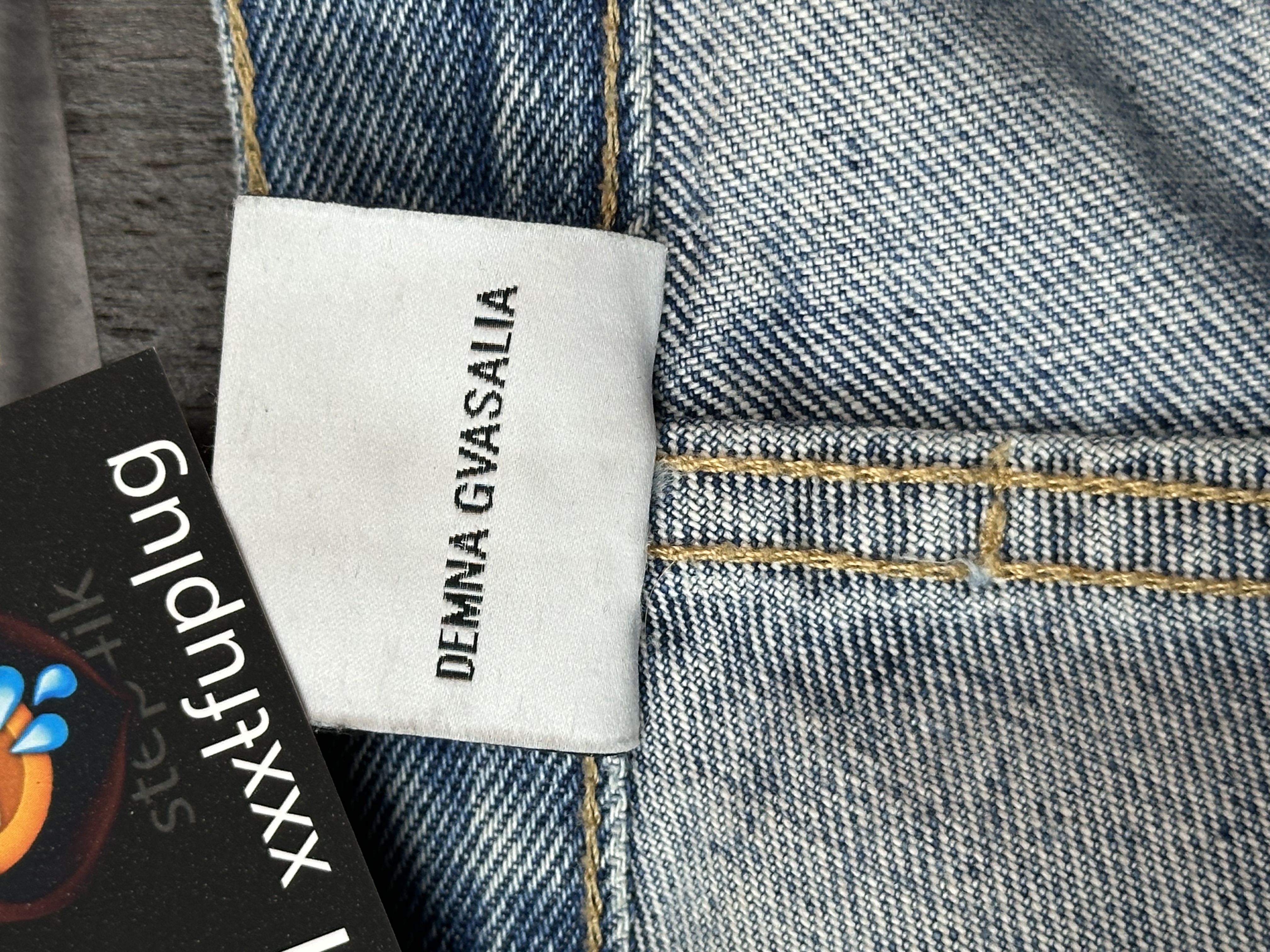 Vetements VETEMENTS FW19 Demna Anarchy Logo Distressed Blue Jeans, detail view 17